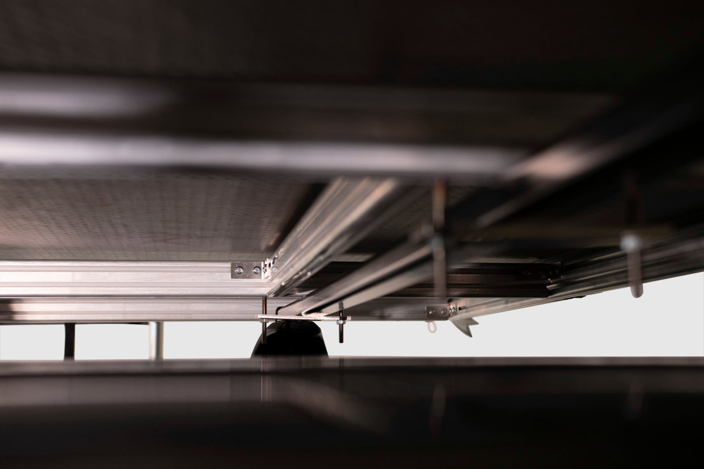 View of the attachment adaptor allowing the rooftop tent to quickly and safely attach to any standard roof rack.