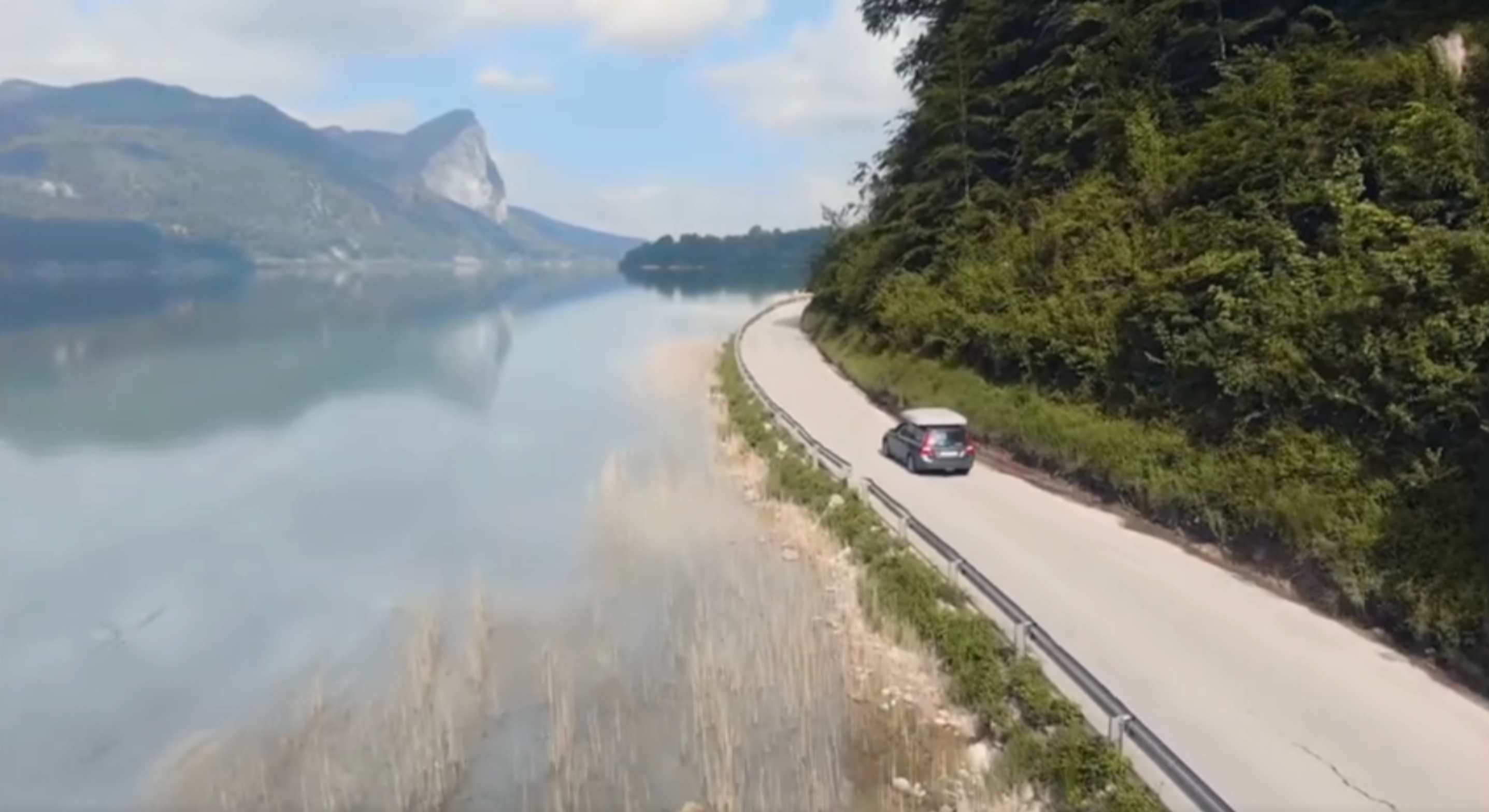 Car driving with a 6 person GT SKY LOFT tent on the roof.